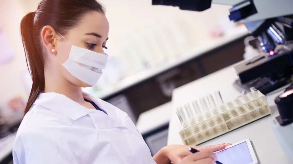 EU and UK cosmetic compliance specialist reviewing laboratory test samples and documentation.