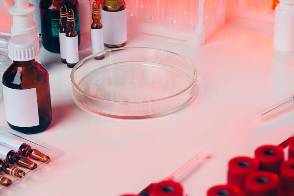 Microbiological testing of cosmetic products in a laboratory, showing petri dishes, test tubes, and scientists performing microbial analysis for UK and EU cosmetic compliance, ISO 11930, and CPSR requirements (2026).