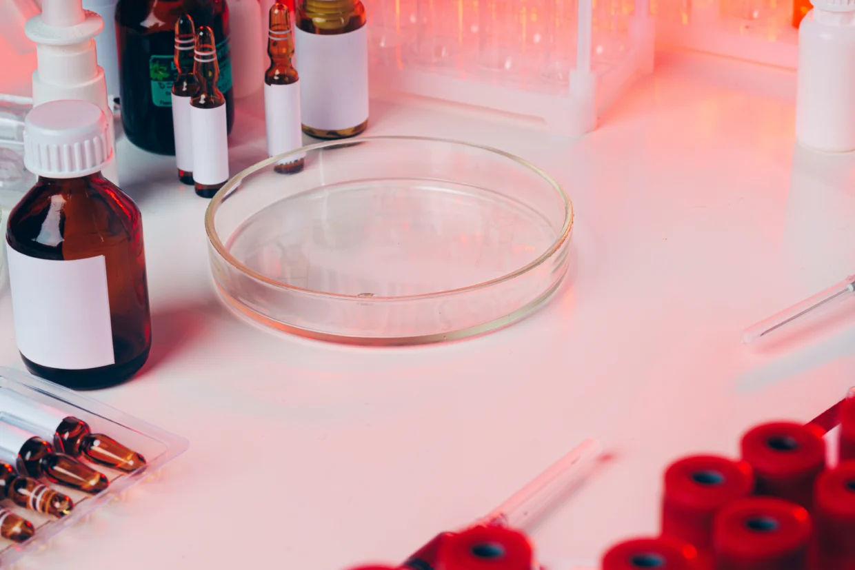Microbiological testing of cosmetic products in a laboratory, showing petri dishes, test tubes, and scientists performing microbial analysis for UK and EU cosmetic compliance, ISO 11930, and CPSR requirements (2026).