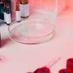 Microbiological testing of cosmetic products in a laboratory, showing petri dishes, test tubes, and scientists performing microbial analysis for UK and EU cosmetic compliance, ISO 11930, and CPSR requirements (2026).